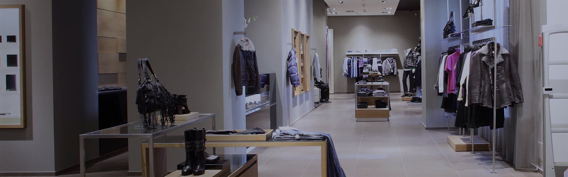 image to show clothes hanging on rails in a clothes shop
