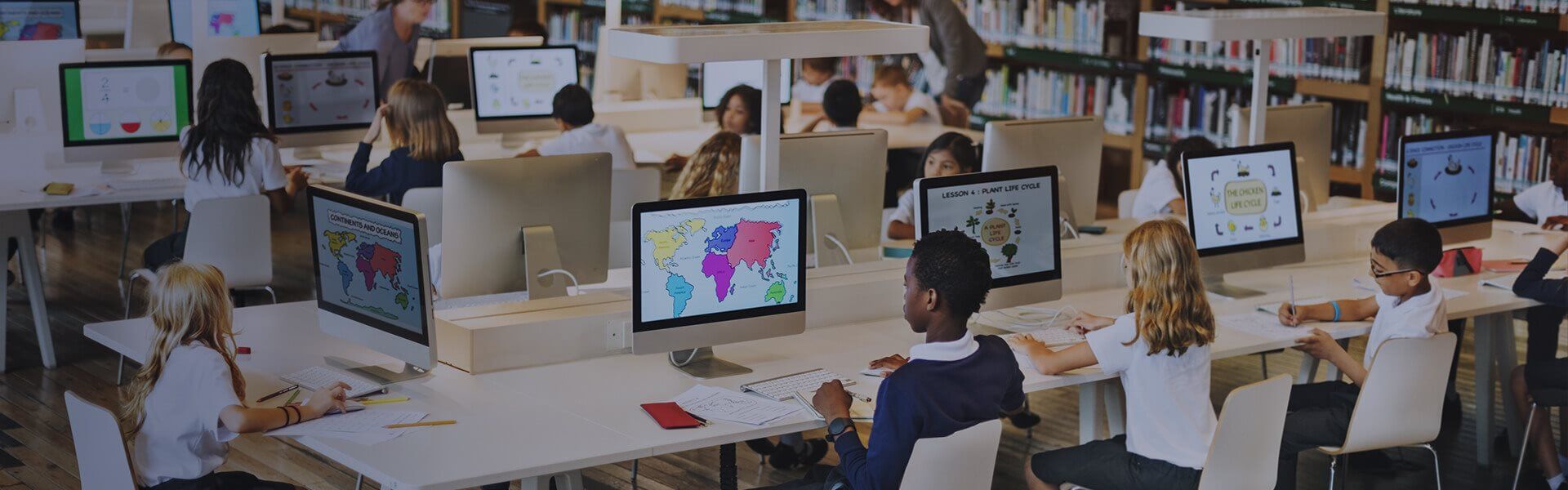 Image of primary school children working on computers in a library