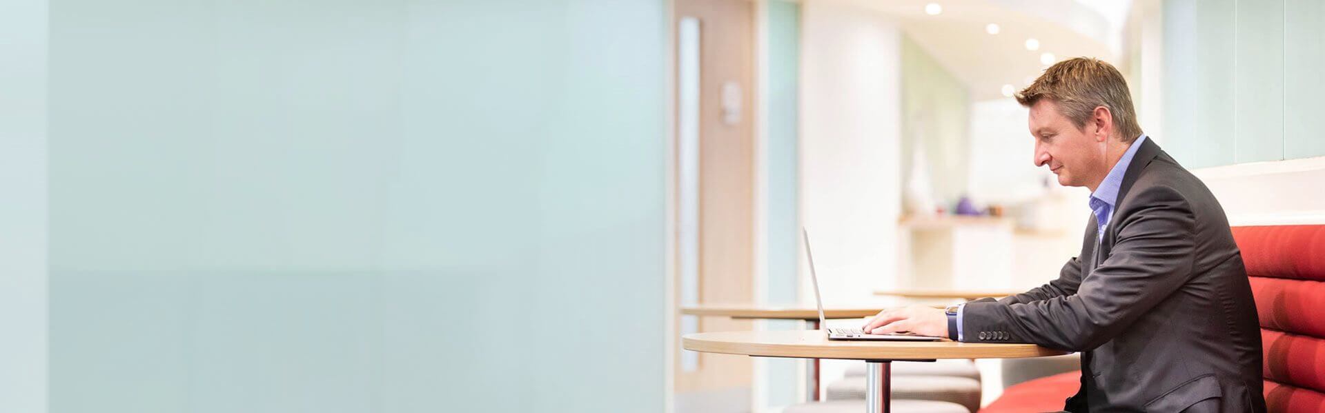 Image of a Browne Jacobson person sat at a desk work on a laptop
