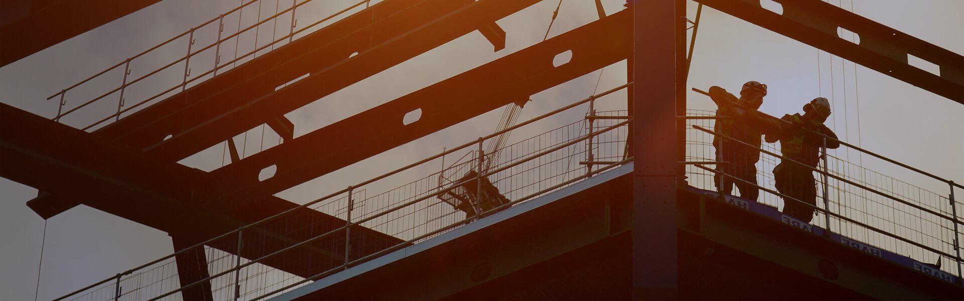 Image of a partially constructed building, with construction workers