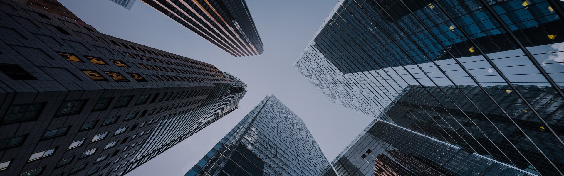 Image from ground level looking up at skyscrapers