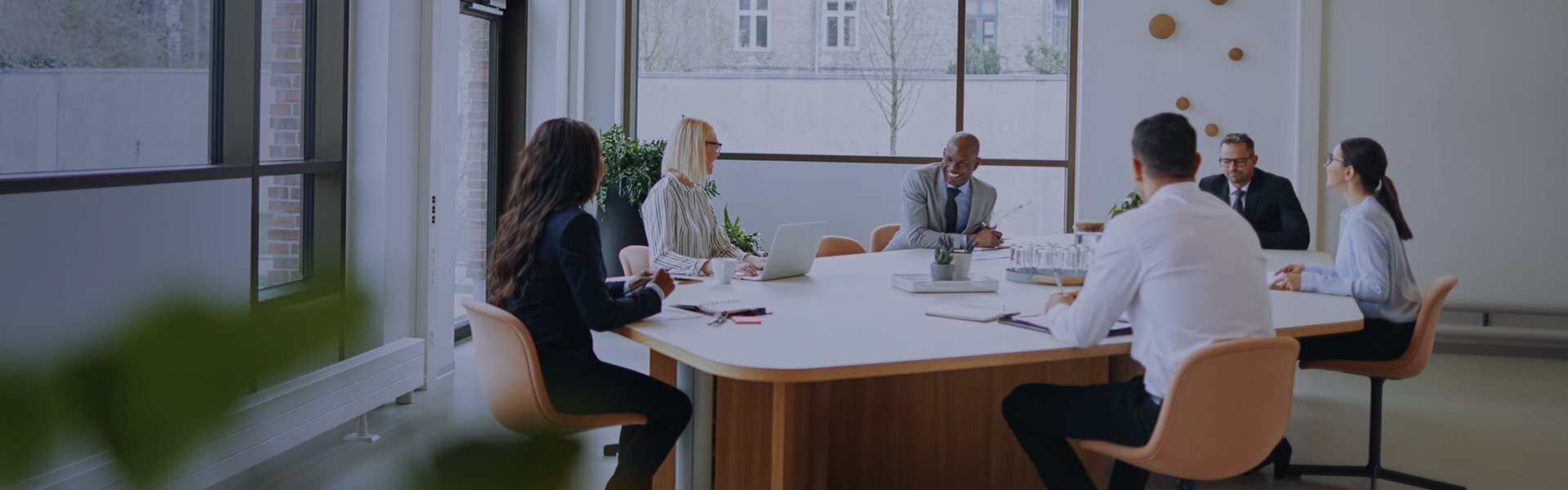 Image of people sat around a table in a meeting room