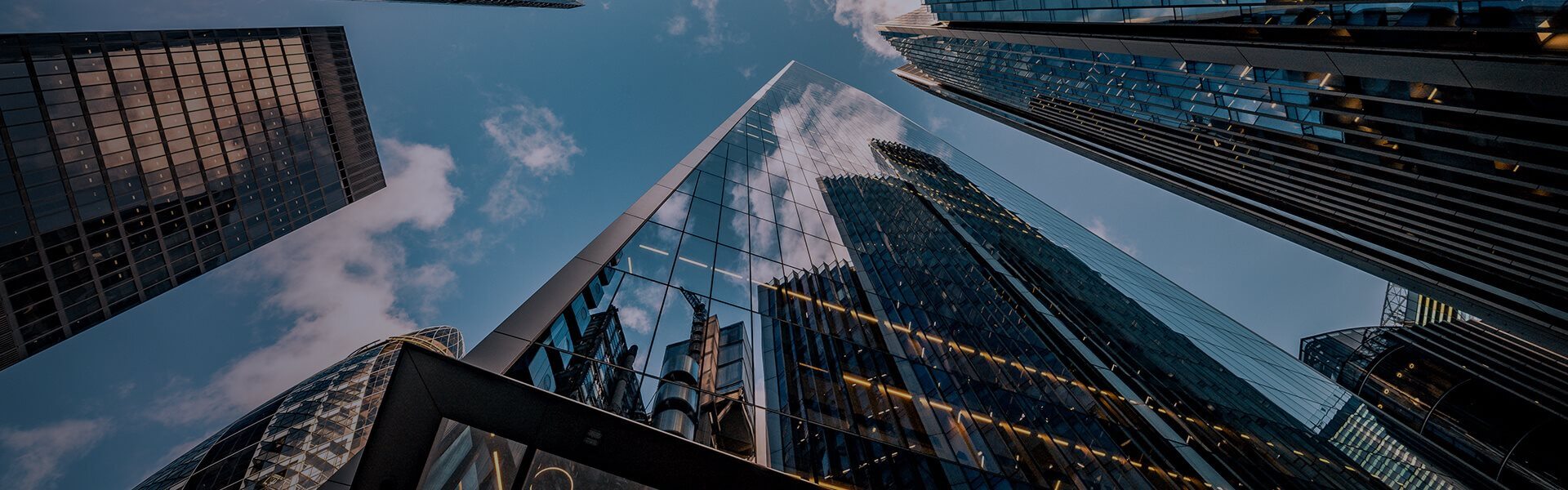 Image looking up at buildings and the sky in London's financial district